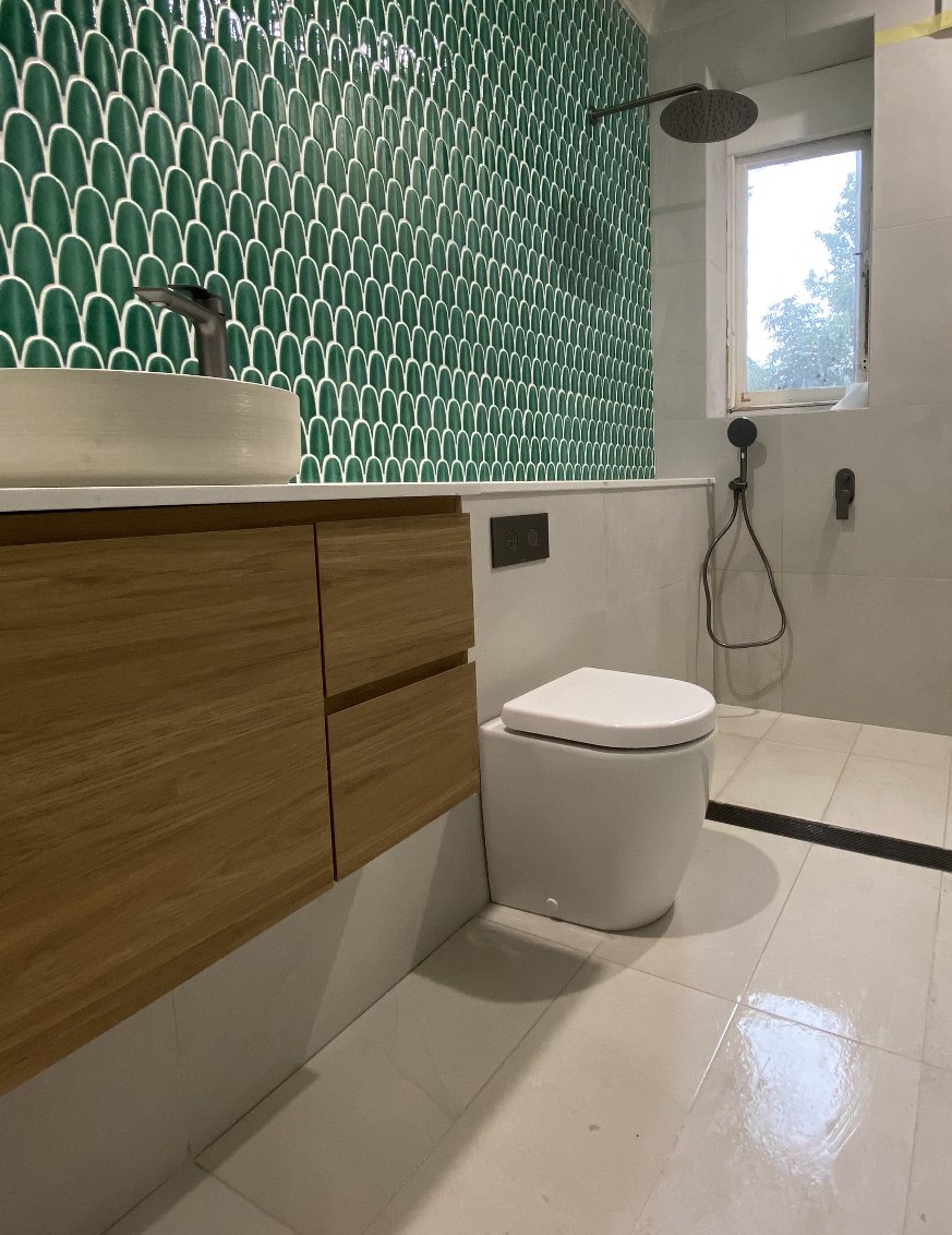 Green scallop tile ensuite with vessel sink and timber vanity