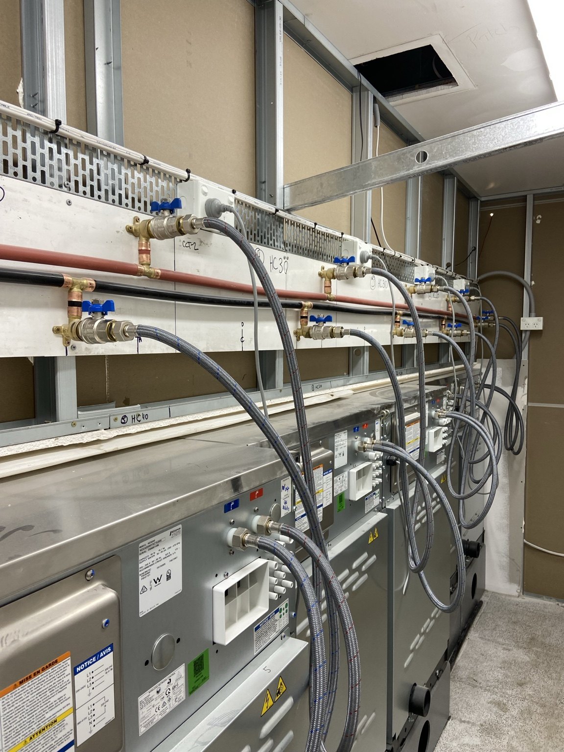 Laundromat machine room plumbing installation